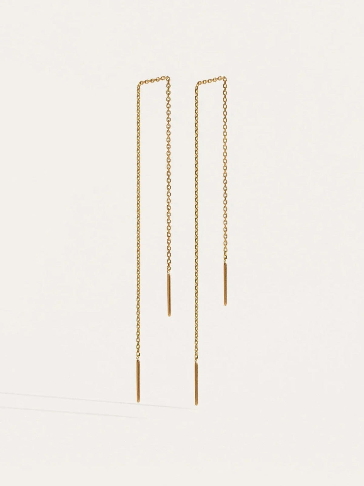 Pair of 24K gold plated ear thread earrings, 9 cm length, with fine chain and small bar ends, on a light background