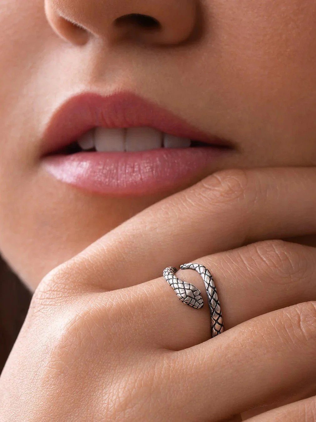 A silver serpent ring with oxidized finish symbolizing resilience and lunar power