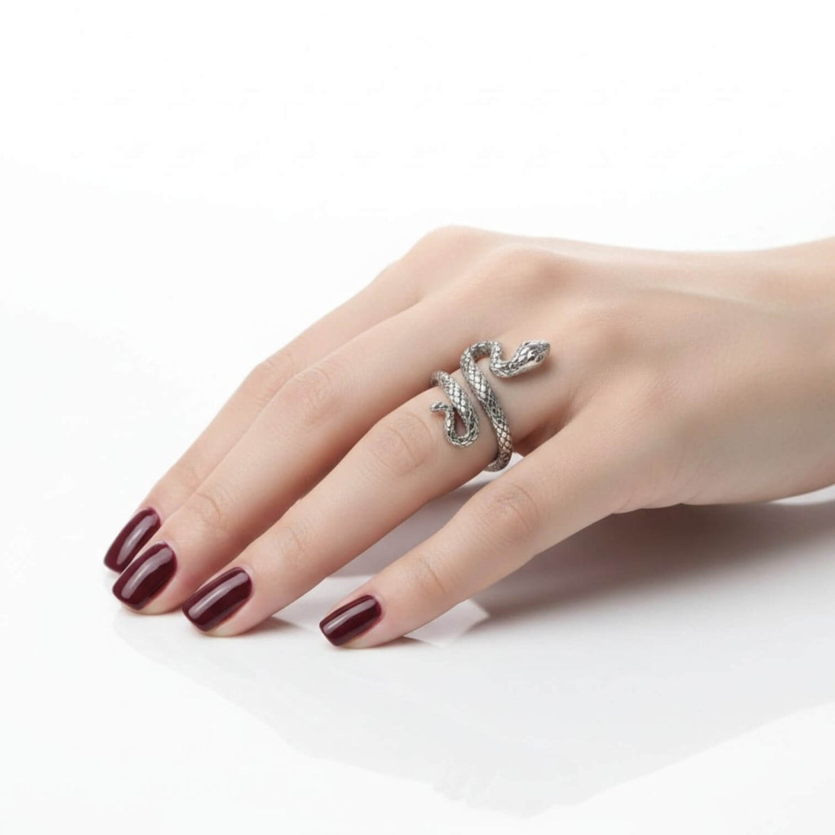 woman wearing on ring finger Sterling Silver Bite Me Snake Wrap Ring with antique silver textured serpent design